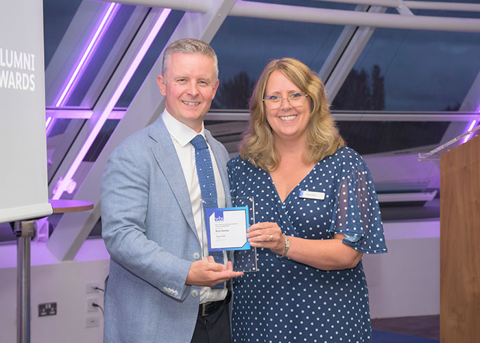 Karen Barker, Director of Stakeholder Engagement presenting Bryn Davies, of Proximie, his Alumni award.