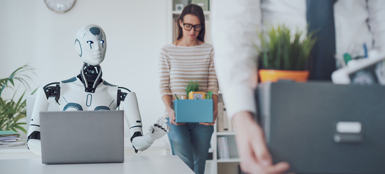 A robot manager sits behind a desk. A robot manager sits behind a desk.